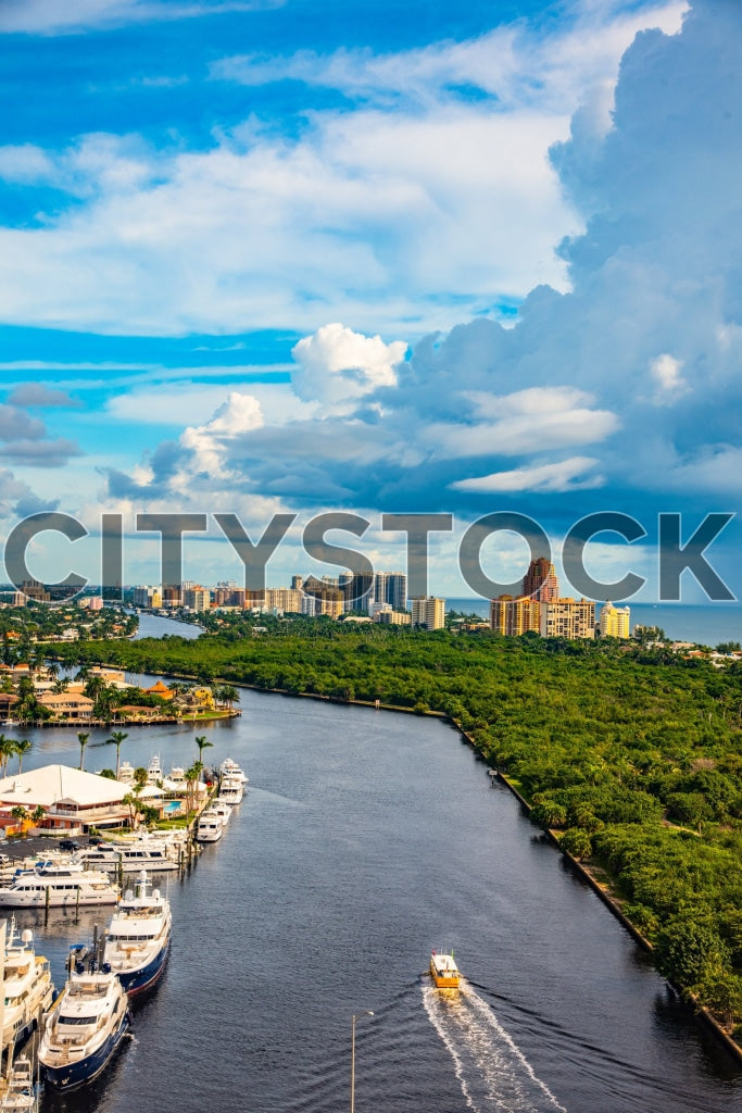 Aerial view of Fort Lauderdale riverside with yachts and skyline under blue sky