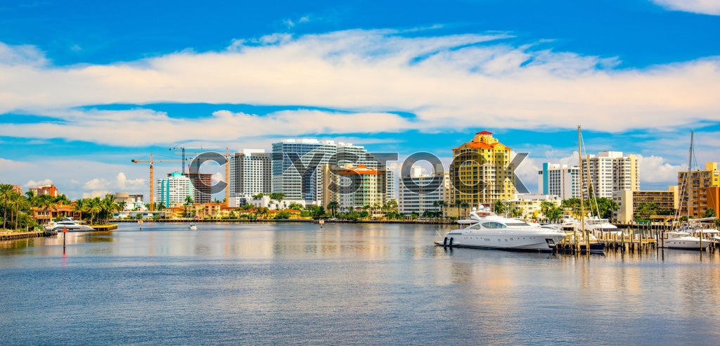 Fort Lauderdale marina with yachts, palm trees, and city skyline