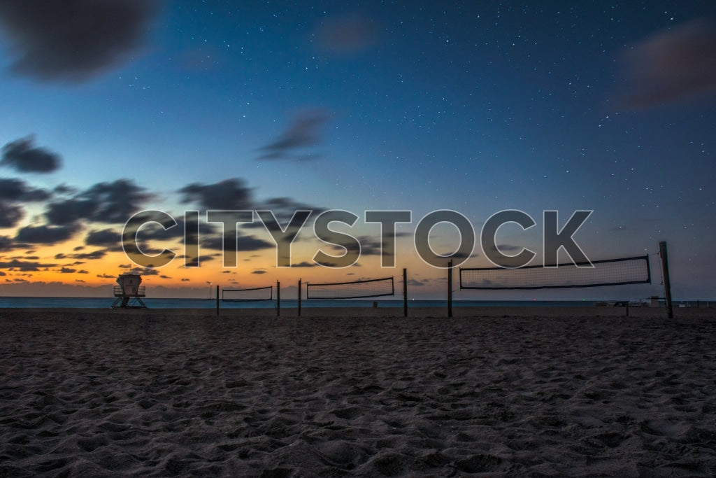 Twilight beach scene with volleyball court and lifeguard stand in Fort Lauderdale, FL