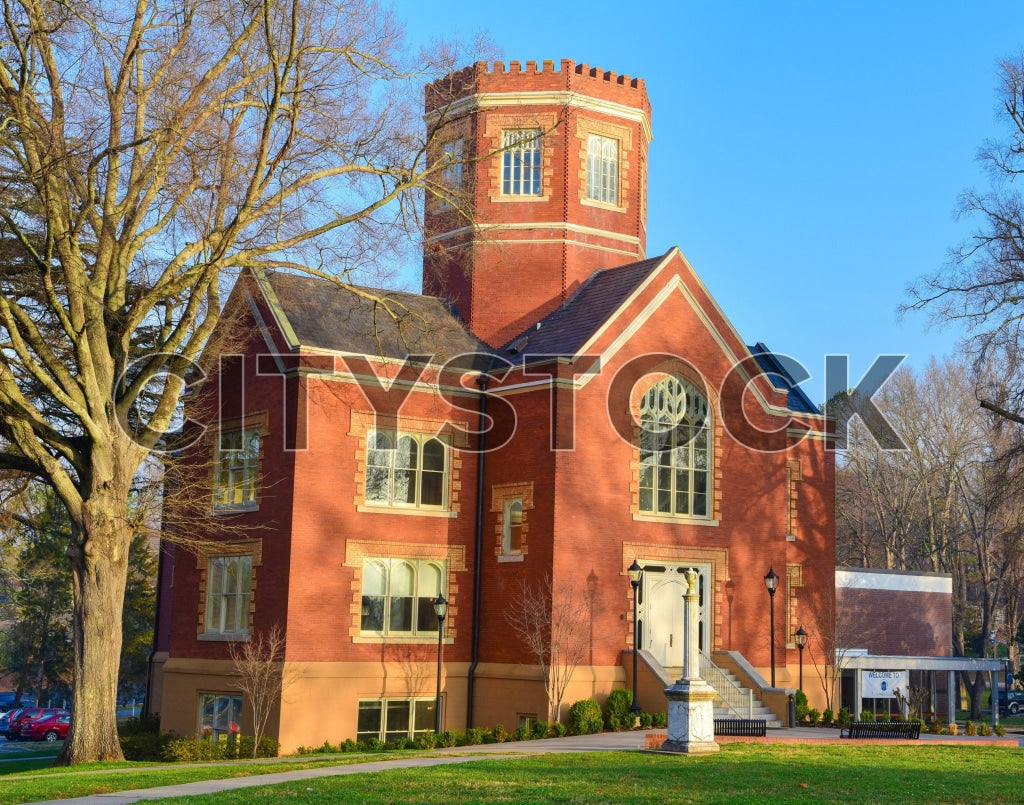 Historic red brick building with tower in Gaffney, SC, under blue sky