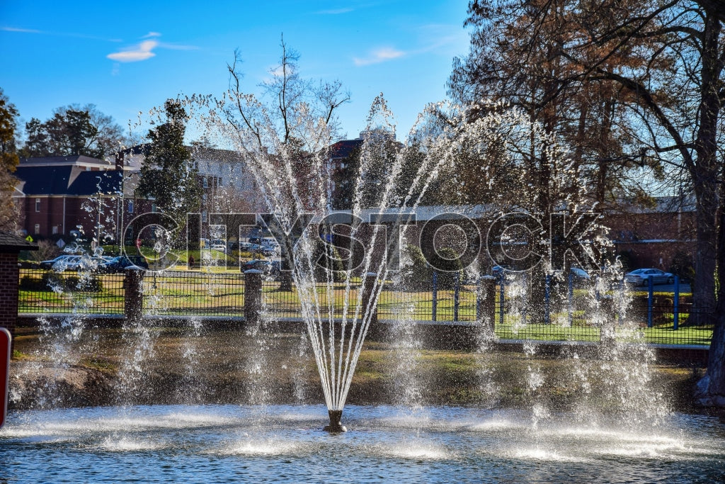 Fountain spraying water on a sunny day in Gaffney, SC with a blue sky background
