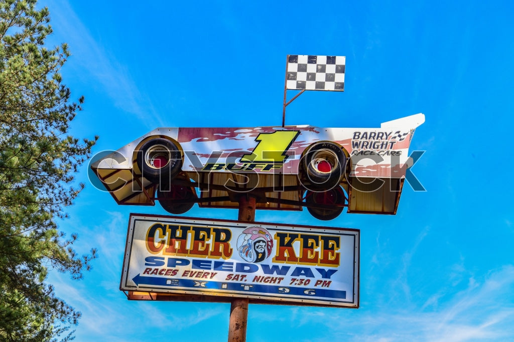 Cherokee Speedway sign with race car graphic under clear blue sky