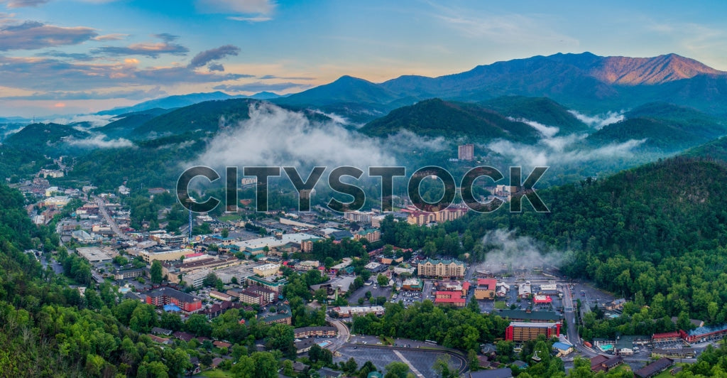 Early morning aerial view of Gatlinburg TN with fog and mountain backdrop