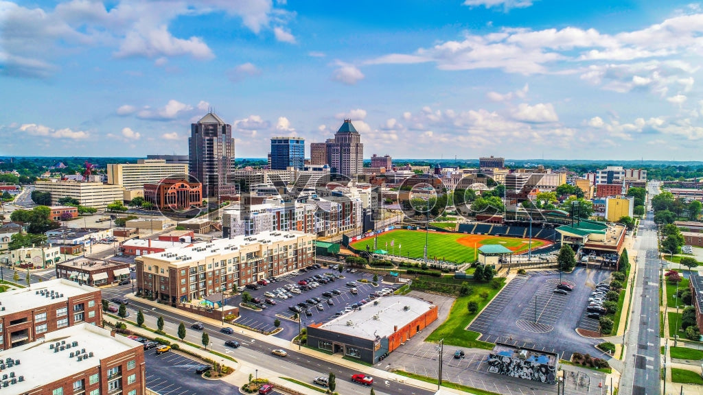 Arial view of Greensboro North Carolina showcasing city and greenspaces