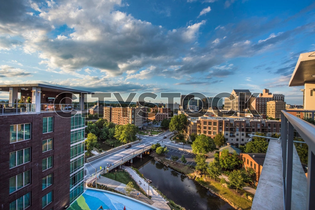 Greenville, SC downtown area with river and sunset skyline
