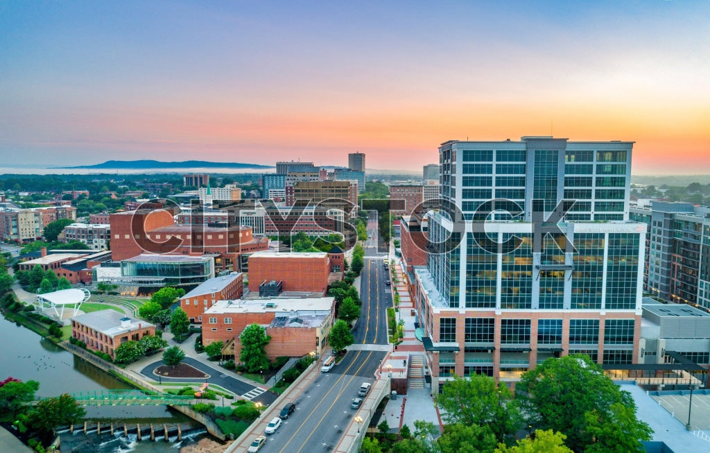 Aerial view of Greenville, SC during sunrise showcasing urban landscape.