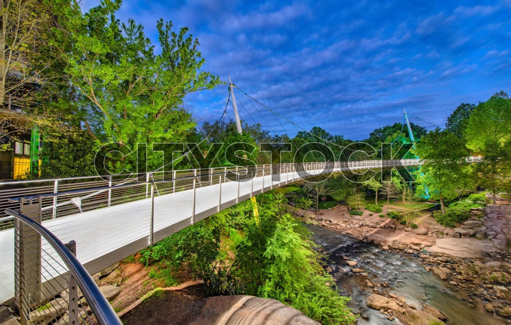 Sunrise view of suspension bridge over river in Greenville, SC