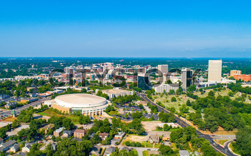 Aerial view of Greenville SC skyline with blue sky and green areas