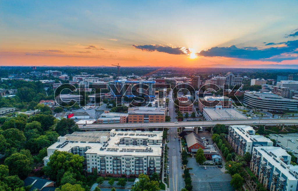 Aerial view of Greenville, SC skyline at sunrise with vibrant hues