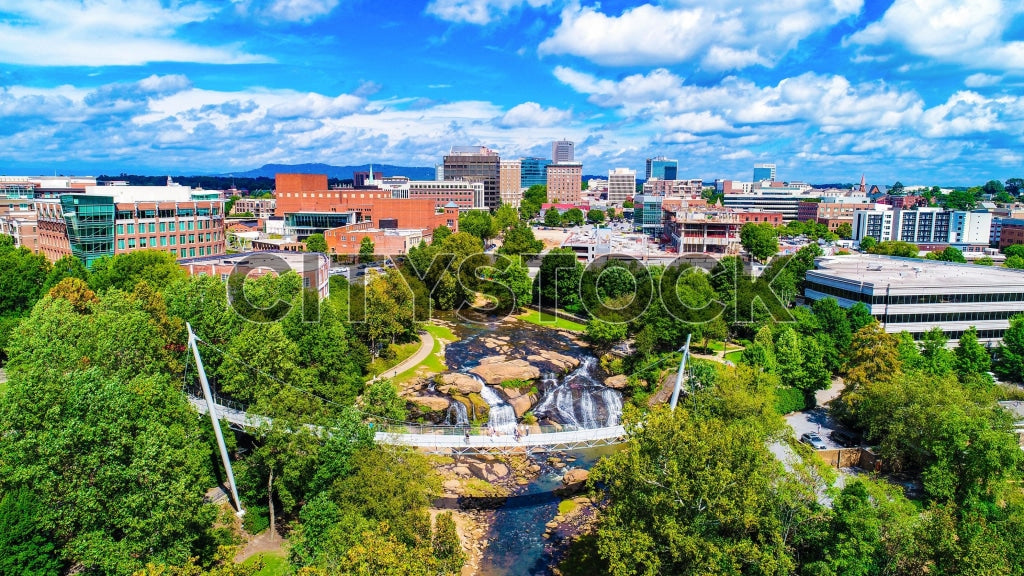 Aerial view Greenville SC cityscape with clear blue sky and lush parks