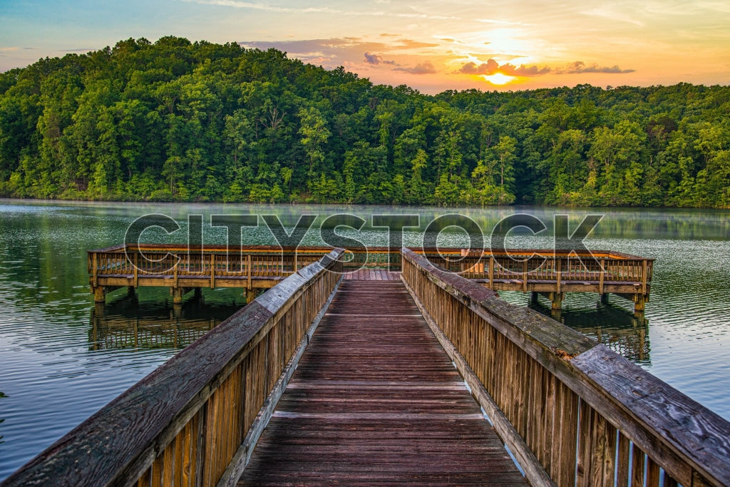 Serene sunset over lake from wooden pier in Greenville, SC