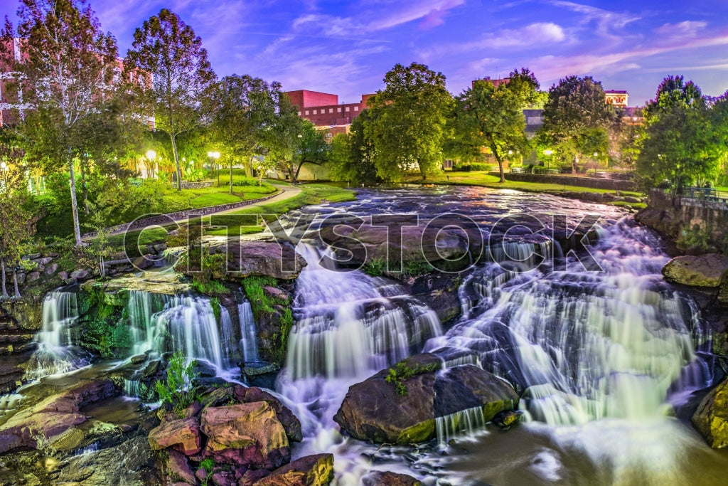 Twilight view of cascading waterfalls and lush park in Greenville, SC