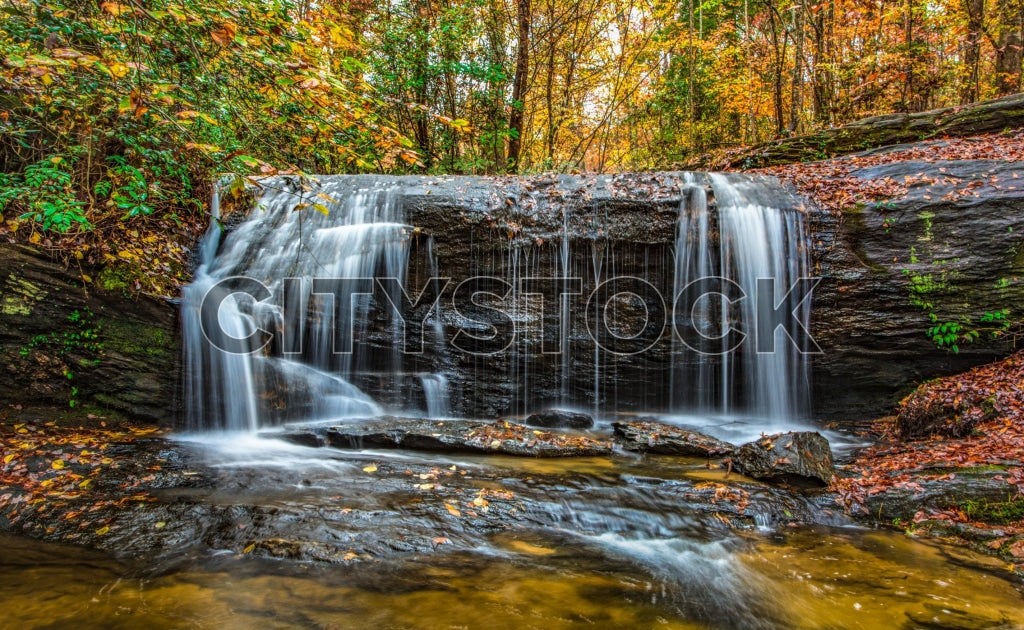 Serene autumn waterfall with vibrant fall foliage in Greenville
