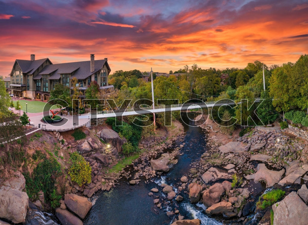 Breathtaking sunset over a luxury building by river in Greenville