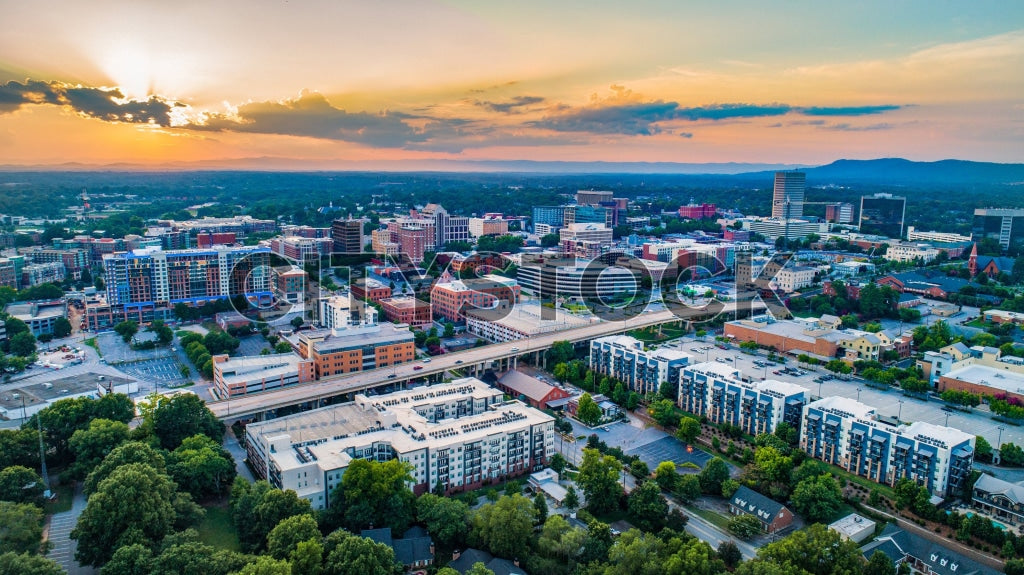 Sunset view of Greenville SC skyline with mountain backdrop