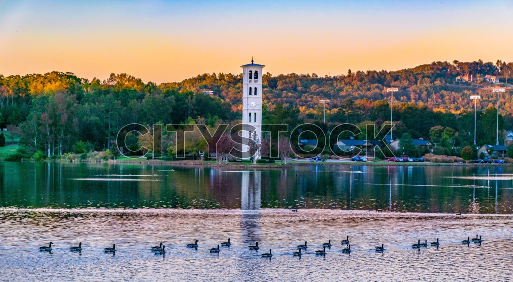 Tranquil sunset view at Lake Greenville with geese and white tower