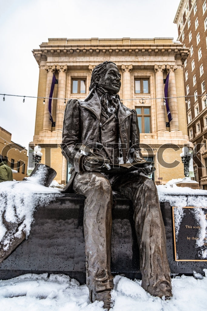 Snow-covered bronze statue in front of the Greenville Courthouse