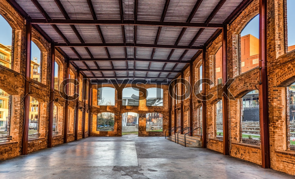 Sunset light casting warm glow in historic Greenville industrial loft