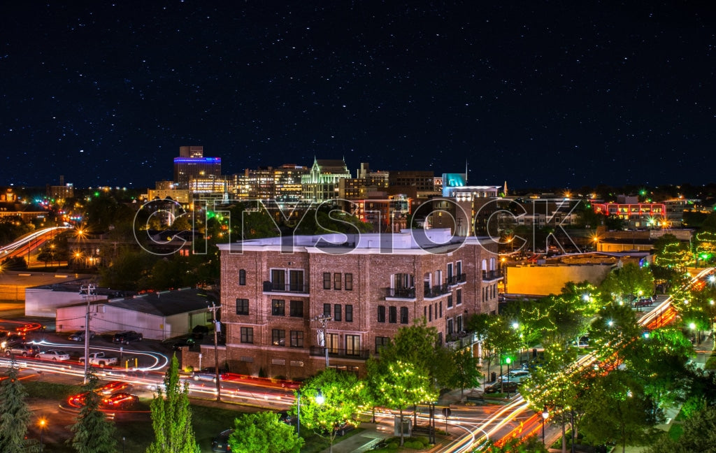 Greenville cityscape at night under starry sky with urban lights