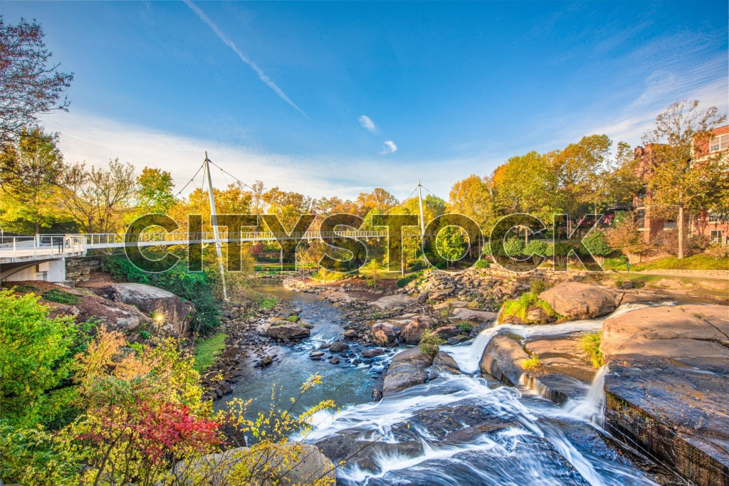 Waterfall in Greenville, SC with autumn trees and clear blue sky