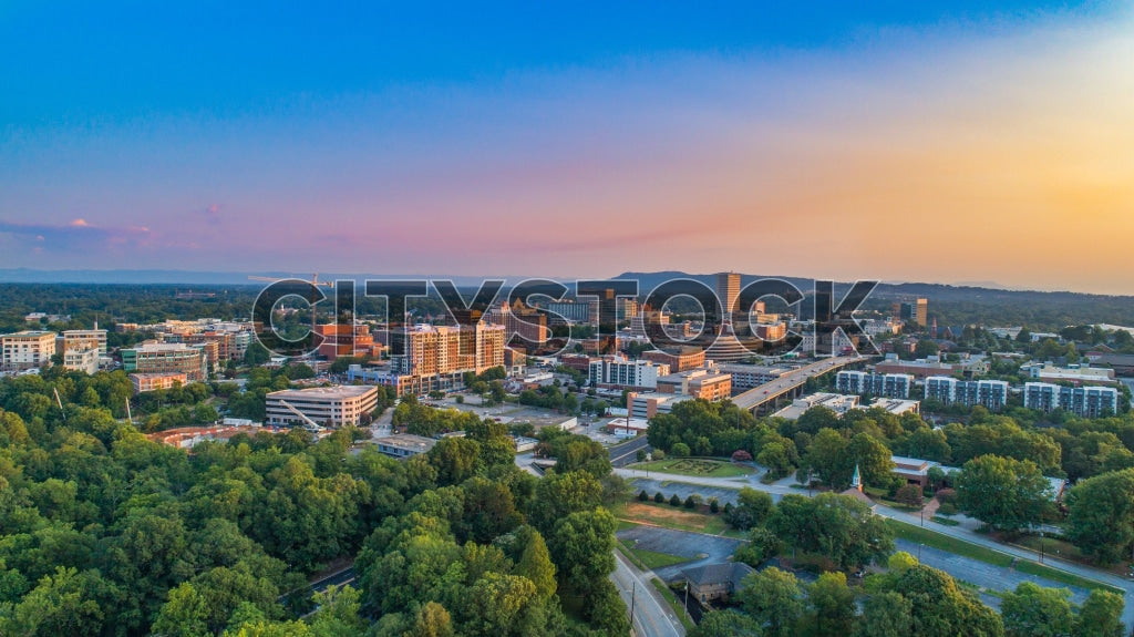 Aerial view of Greenville, SC skyline at sunset with mountains