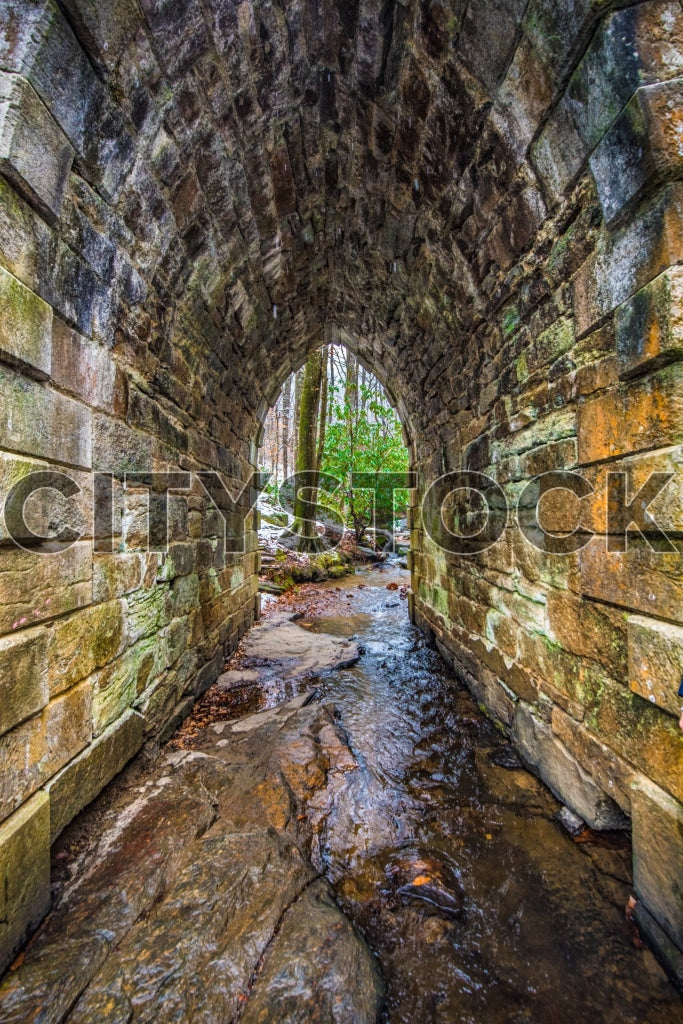 Historic stone arch with flowing stream in Greenville, SC