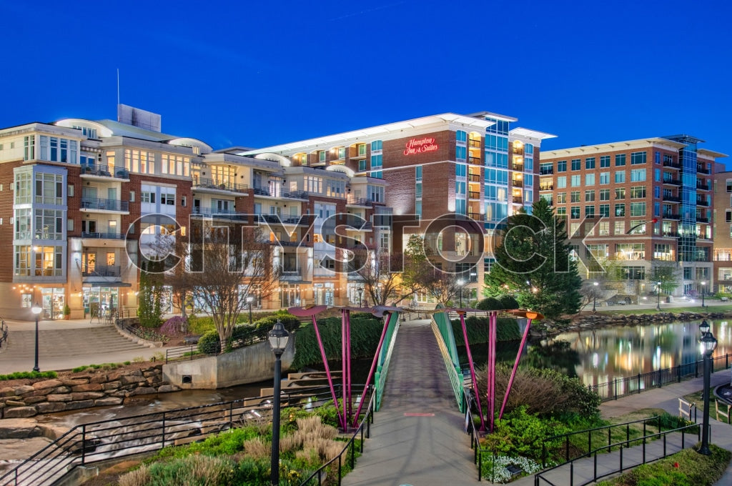 Twilight view of Greenville Riverwalk with residential buildings