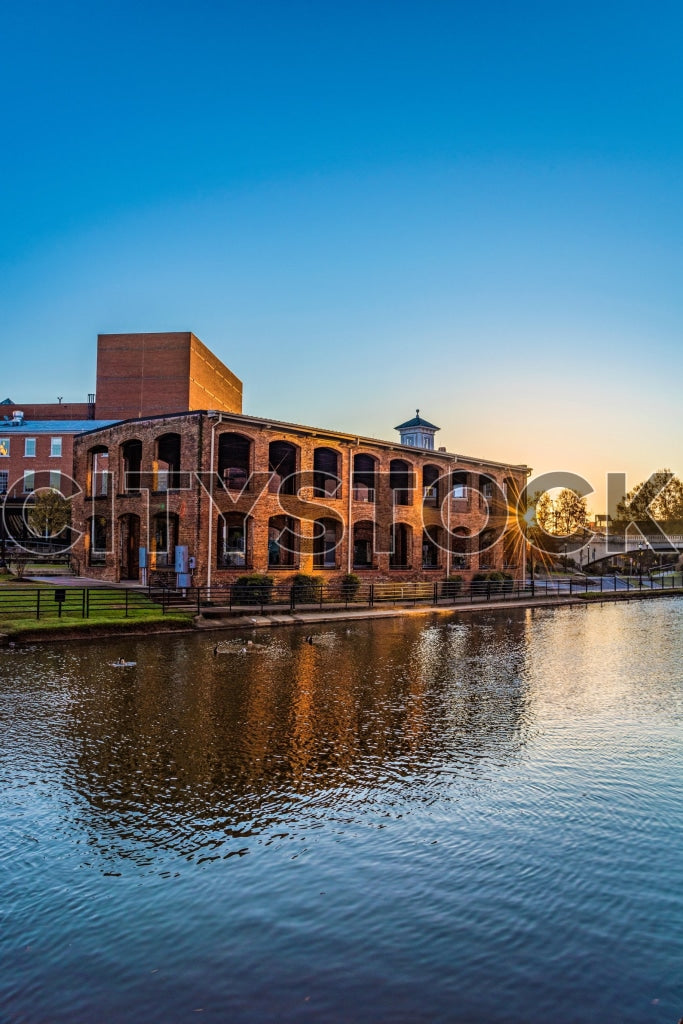 Historic waterfront building in Greenville at sunset with reflections