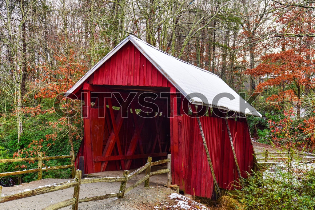 Red wooden bridge surrounded by autumn leaves in Greenville, SC