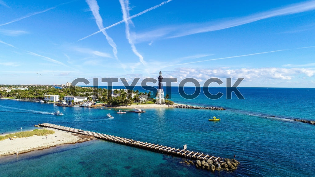 Aerial view of Hillsboro Lighthouse with Atlantic coastline and boats