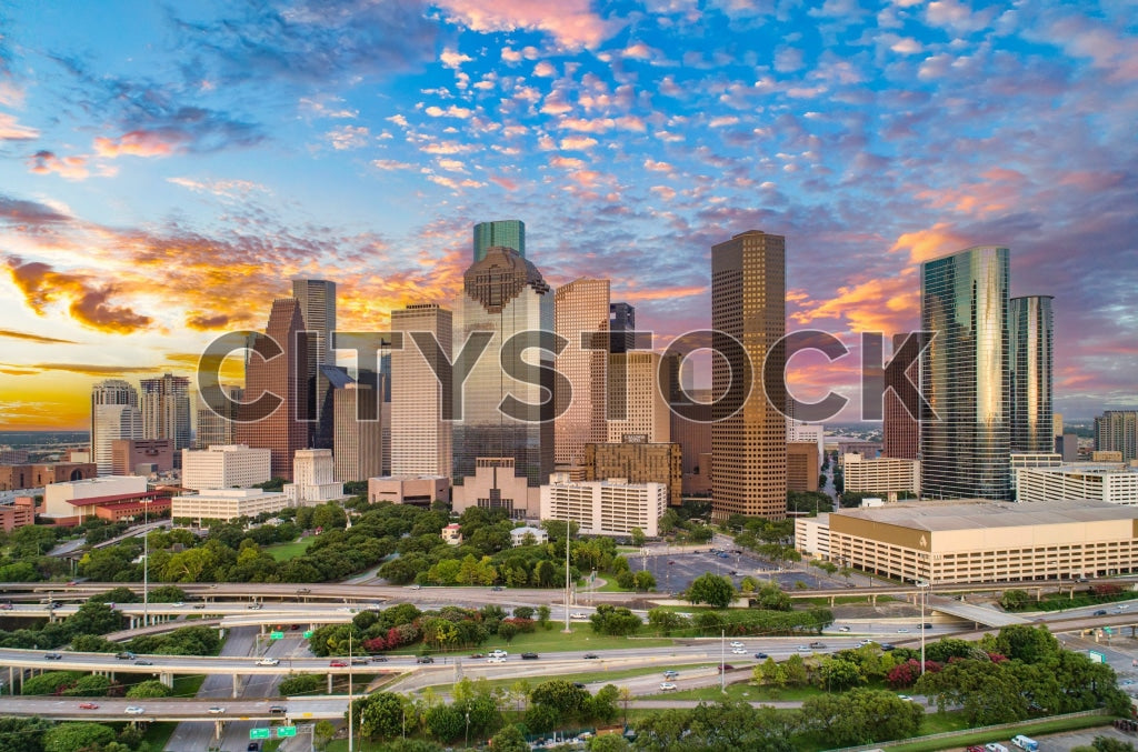 Aerial view of Houston skyline at sunset with colorful clouds