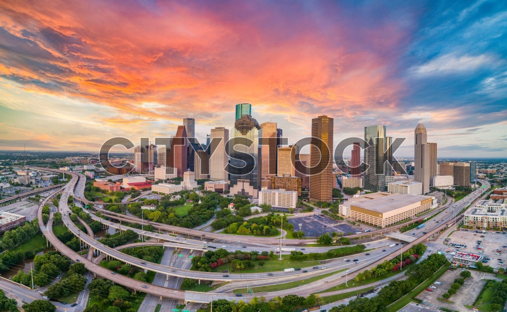 Aerial view of Houston skyline with sunset and colorful clouds