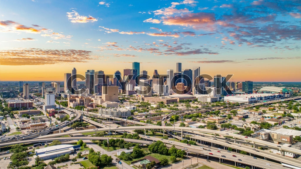 Aerial view of Houston skyline at sunrise with skyscrapers and highways
