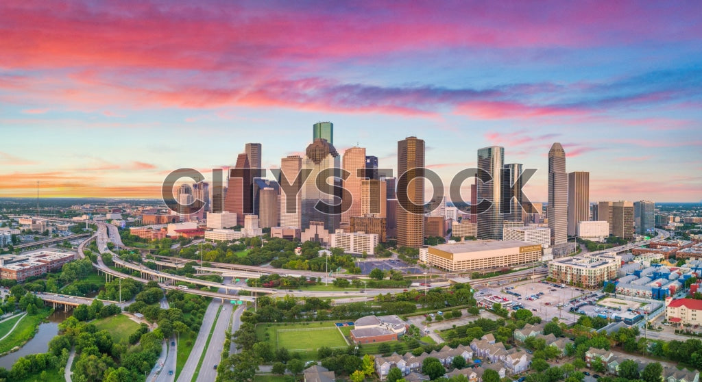Aerial view of Houston skyline during sunrise with vibrant skies