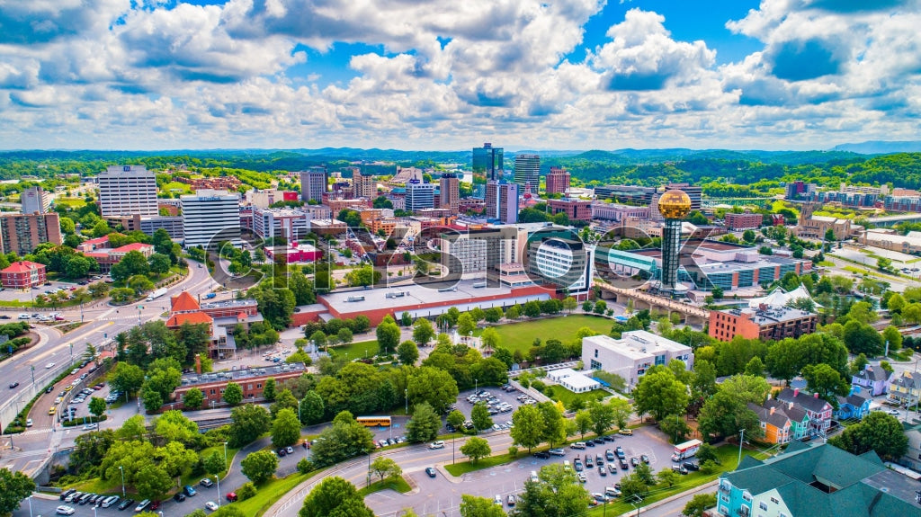 Aerial view of Knoxville skyline with Sunsphere under blue sky