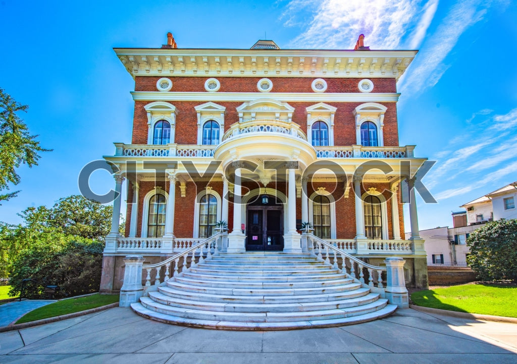 Elegant Southern red brick mansion under blue sky in Macon, Georgia