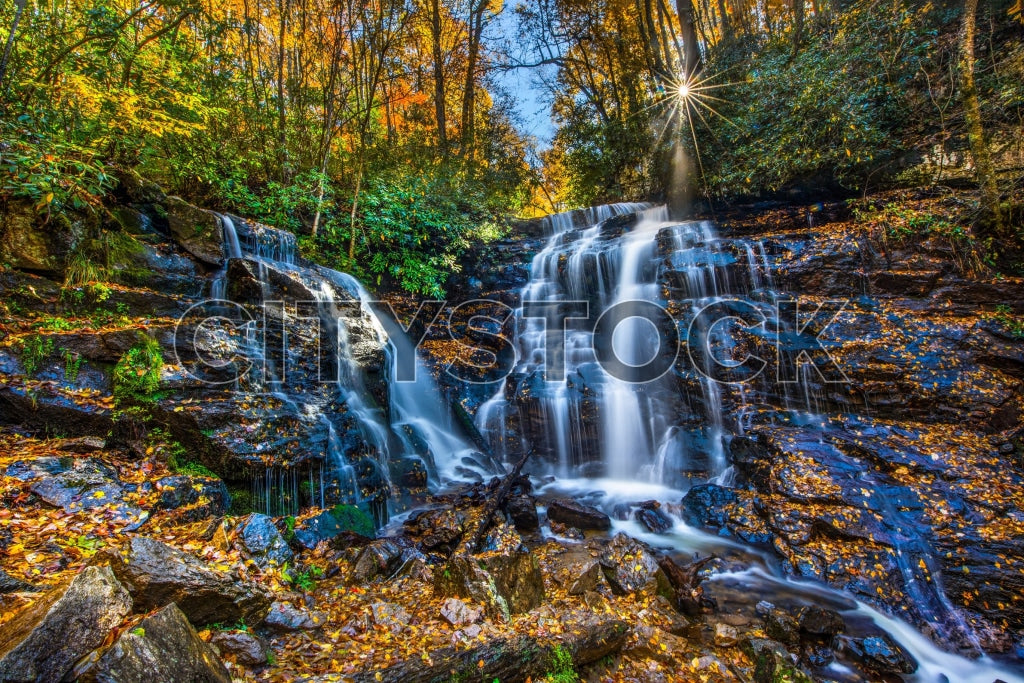 Autumn waterfall with sunburst through trees in Maggie Valley, NC