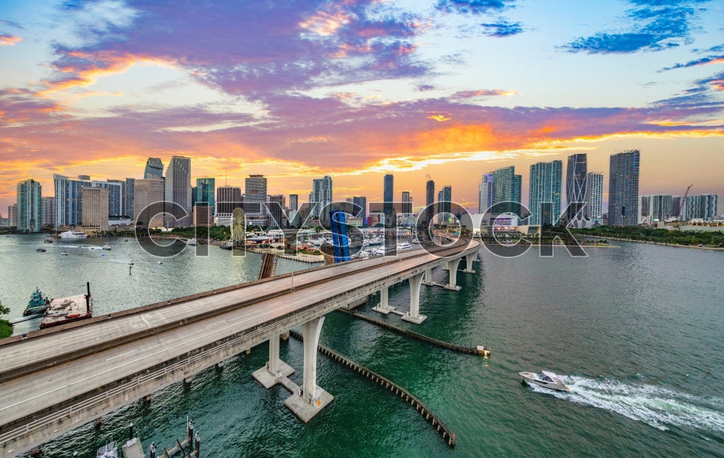 Aerial view of Miami skyline at sunset with vibrant skies and active waterways