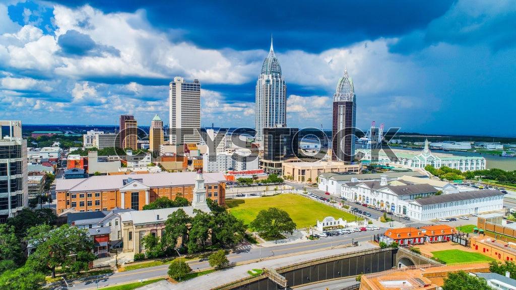 Aerial view of Mobile, Alabama skyline under bright blue sky