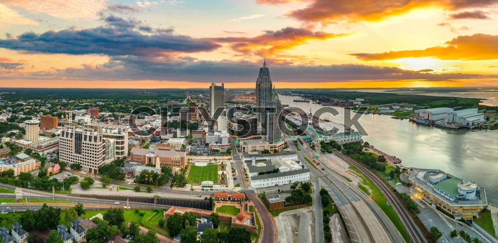 Aerial view of Mobile, Alabama cityscape at sunrise with modern architecture.