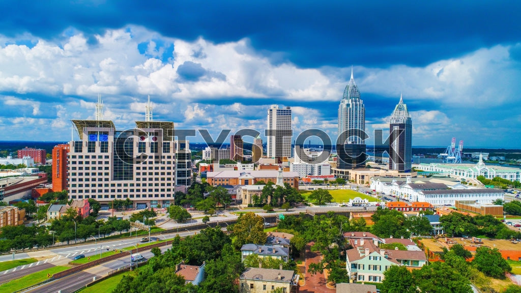 Aerial cityscape of downtown Mobile, Alabama with blue skies and skyscrapers