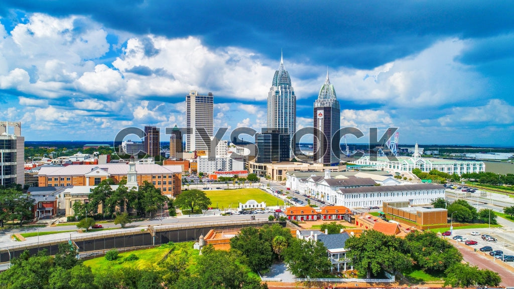 Aerial view of Mobile, Alabama skyline under cloudy skies