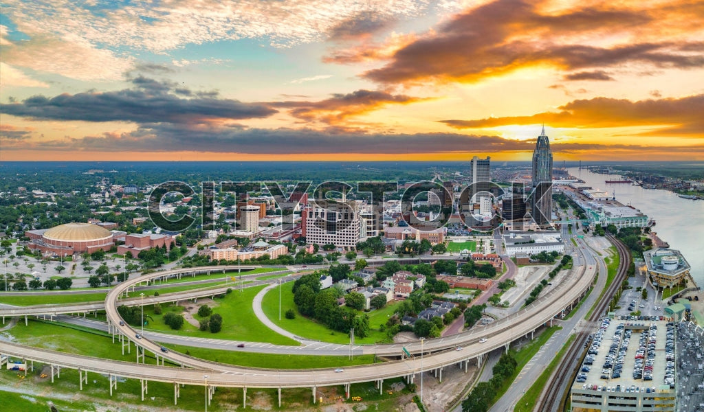 Aerial view of Mobile, Alabama skyline at sunset with vibrant hues