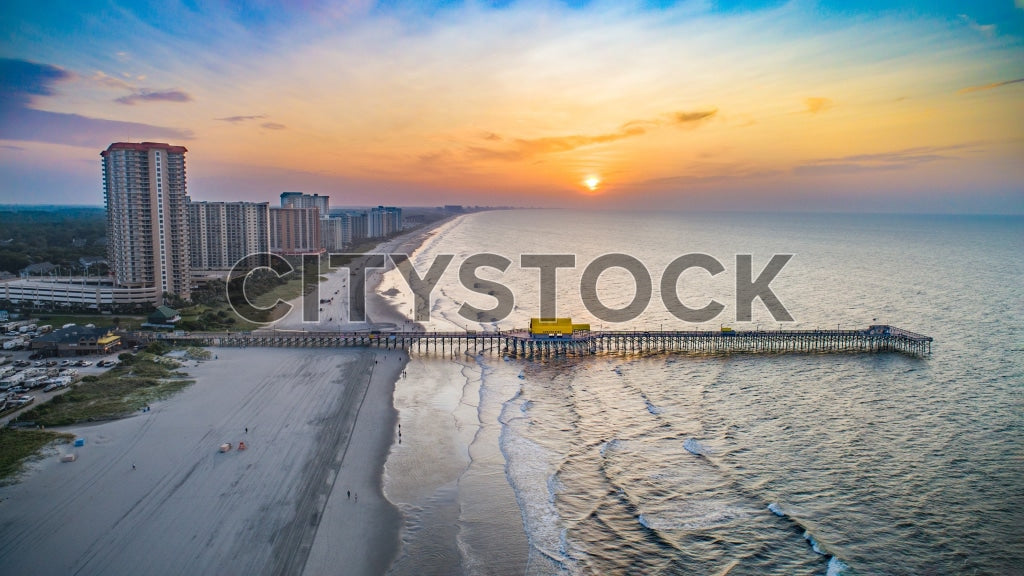 Aerial view of sunset over Myrtle Beach with pier and high-rises