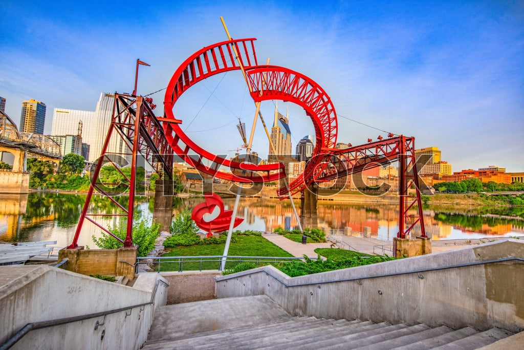 Nashville skyline and red sculpture reflecting in river at sunrise