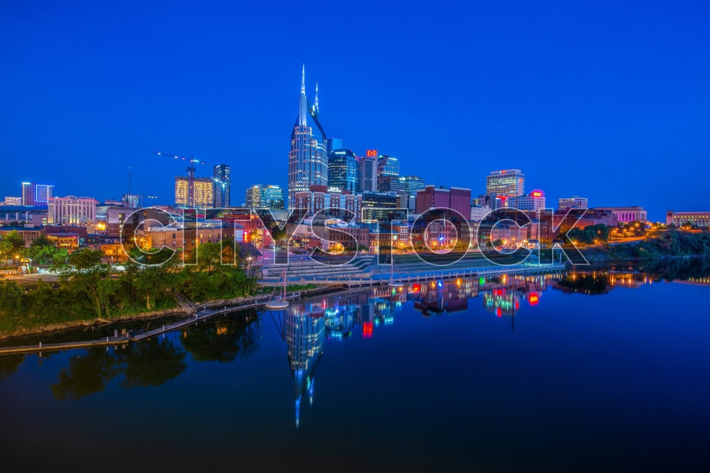 Nashville skyline at twilight, lights reflecting in Cumberland River
