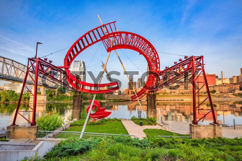 Nashville city skyline and red sculpture by the river at sunrise