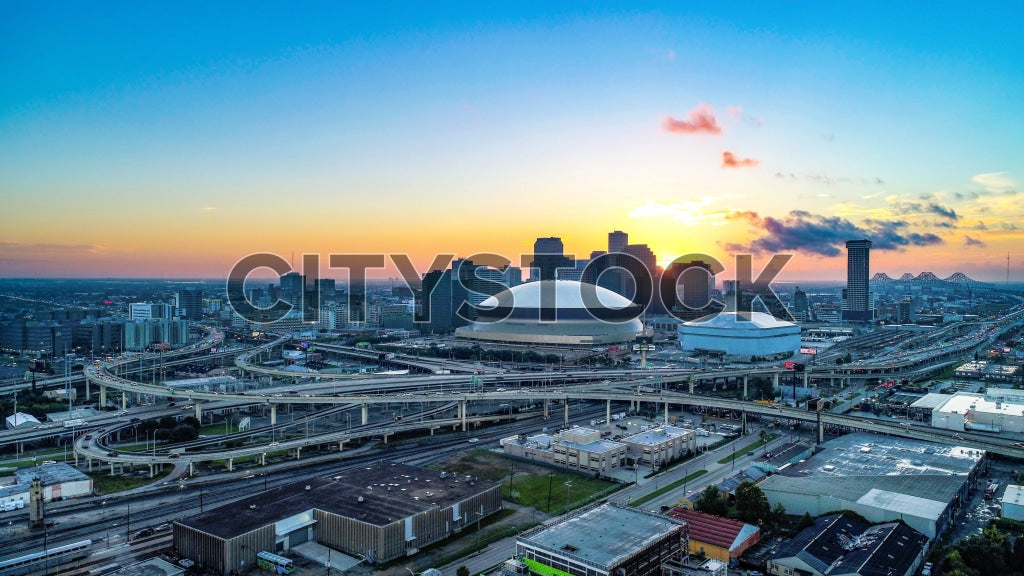Aerial view of New Orleans skyline and highways at sunrise