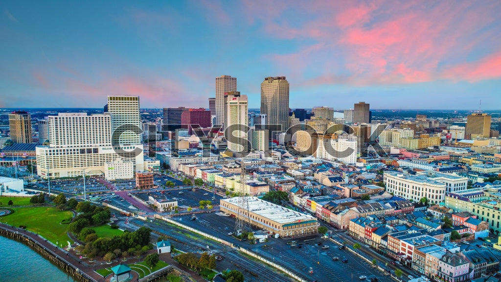 Aerial view of New Orleans cityscape at sunrise showing vibrant hues