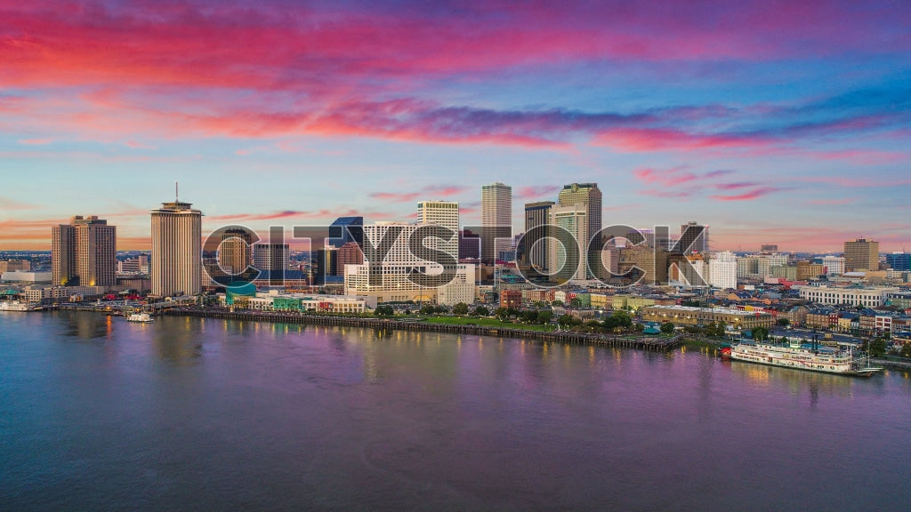 Aerial view of New Orleans skyline with colorful sunset